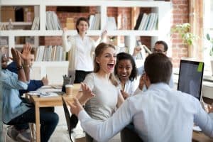 team of business executives celebrating success